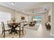 Cozy living room with ample natural light and a view of the backyard at 3835 Autumn Fern Ter, Sarasota, FL 34243