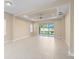 Spacious living area with tile floors and sliding glass doors to the lanai at 3835 Autumn Fern Ter, Sarasota, FL 34243