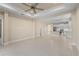 Spacious open floor plan with lots of natural light and tile flooring connecting the living area to the kitchen at 3835 Autumn Fern Ter, Sarasota, FL 34243