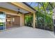 A screened-in patio with lush green plants and an open sliding door leading to the kitchen area at 3835 Autumn Fern Ter, Sarasota, FL 34243