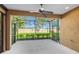 Screened patio with a ceiling fan, offering a peaceful outdoor space with views of the well-maintained backyard at 3835 Autumn Fern Ter, Sarasota, FL 34243
