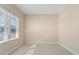 A light and airy room features neutral walls, a window with blinds, and tile flooring, offering a versatile space at 3835 Autumn Fern Ter, Sarasota, FL 34243