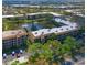An aerial view of condos surrounded by lush trees and water features in a beautiful community at 425 30Th W Ave # C201, Bradenton, FL 34205