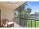 Relaxing screened balcony with outdoor seating overlooking the pond and community greenery at 425 30Th W Ave # C201, Bradenton, FL 34205