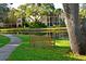 Peaceful spot with a wooden bench to relax and enjoy the tranquil pond views at 425 30Th W Ave # C201, Bradenton, FL 34205
