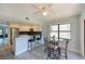 Bright dining area with modern ceiling fan and view to the kitchen at 425 30Th W Ave # C201, Bradenton, FL 34205