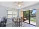 Bright dining area with glass table, patio access, and views of the landscaped grounds and water at 425 30Th W Ave # C201, Bradenton, FL 34205