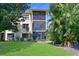 Screened lanais on the back of this condo offer a relaxing outdoor living space surrounded by lush tropical plants at 425 30Th W Ave # C201, Bradenton, FL 34205