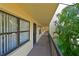 Exterior hallway with railing and view of the lush landscaping and nearby greenery at 425 30Th W Ave # C201, Bradenton, FL 34205