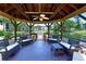 Relaxing gazebo view with comfortable seating overlooking a serene pond and manicured grounds at 425 30Th W Ave # C201, Bradenton, FL 34205