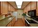 Galley kitchen with ample cabinet space and modern appliances, creating a functional cooking area at 425 30Th W Ave # C201, Bradenton, FL 34205