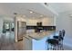 Well-lit kitchen with stainless steel appliances, granite countertops, and a breakfast bar with seating at 425 30Th W Ave # C201, Bradenton, FL 34205