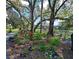 Beautifully landscaped area with vibrant flowers, mature trees, and tranquil pond views at 425 30Th W Ave # C201, Bradenton, FL 34205