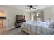 Bright main bedroom featuring a ceiling fan, updated floors, and views of the community pond at 425 30Th W Ave # C201, Bradenton, FL 34205