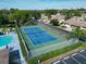 Community tennis court alongside a pool and shuffleboard area at 425 30Th W Ave # C201, Bradenton, FL 34205