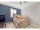 This bedroom boasts a carpeted floor, blue accent wall, and a lightly colored bed at 4702 Vasca Dr, Sarasota, FL 34240