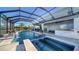 An inviting screened-in pool with spa and outdoor seating area at 4702 Vasca Dr, Sarasota, FL 34240