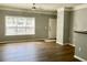 Comfortable living room with neutral paint, wood floors, and a large window with access to the entry door at 4802 51St W St # 1420, Bradenton, FL 34210