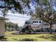 Community playground with slide, swings, and climbing structures, nestled among mature trees and green space at 4802 51St W St # 1420, Bradenton, FL 34210