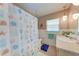 Bathroom featuring seashell-themed shower curtain, vanity, and decorative accents at 508 67Th Avenue W Dr, Bradenton, FL 34207