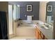 Bright bathroom with white tile, wooden cabinets, and separate tub and shower at 509 Stone Briar Dr, Ruskin, FL 33570