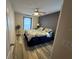 Well-lit bedroom with wood-look flooring, ceiling fan and neutral color palette at 509 Stone Briar Dr, Ruskin, FL 33570