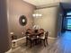 Charming dining room with modern chandelier and a decorative mirror creating an inviting ambiance at 509 Stone Briar Dr, Ruskin, FL 33570