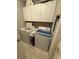 Efficient laundry room with washer, dryer, upper cabinets, and tile floor at 509 Stone Briar Dr, Ruskin, FL 33570