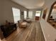 Cozy sitting room bathed in natural light with neutral walls and stylish wood laminate flooring at 509 Stone Briar Dr, Ruskin, FL 33570