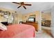 Bright bedroom featuring a king bed, dresser, and adjacent sitting area at 515 30Th Ave W # H410, Bradenton, FL 34205