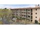Multi-story condo building showing private balconies, surrounded by lush trees and ample parking in a well-maintained community at 515 30Th Ave W # H410, Bradenton, FL 34205