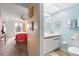 Hallway leading to a bedroom and a charming bathroom featuring light blue walls at 515 30Th Ave W # H410, Bradenton, FL 34205