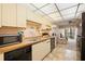 Bright kitchen featuring light wood cabinets with modern appliances at 515 30Th Ave W # H410, Bradenton, FL 34205