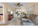 Cozy living room featuring carpet floors, a ceiling fan, a television, and comfortable seating at 515 30Th Ave W # H410, Bradenton, FL 34205