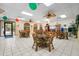 Bright community room with ceiling fans, round tables, and chairs, perfect for gatherings at 515 30Th Ave W # H410, Bradenton, FL 34205