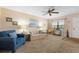 Bright living room with a sofa and chair, complemented by natural light from a large window at 515 30Th Ave W # H410, Bradenton, FL 34205