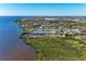 Aerial view of waterfront condos near the water with lush landscape and scenic views at 515 Leffingwell Ave # 210, Ellenton, FL 34222