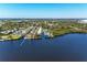 An aerial view of waterfront townhouses with boat docks extending into the dark water, showcasing a serene coastal living at 515 Leffingwell Ave # 210, Ellenton, FL 34222