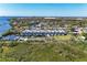 An aerial shot of waterfront townhouses with private boat docks and a community pool and tennis court at 515 Leffingwell Ave # 210, Ellenton, FL 34222