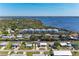 Aerial view of waterfront townhouses situated along a canal leading to a wide river, surrounded by lush greenery at 515 Leffingwell Ave # 210, Ellenton, FL 34222