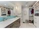 Bright bathroom featuring a double sink vanity and custom closet with shelving at 515 Leffingwell Ave # 210, Ellenton, FL 34222
