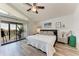Cozy bedroom with balcony access, featuring a ceiling fan and natural light at 515 Leffingwell Ave # 210, Ellenton, FL 34222