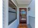 Inviting front door with 'Welcome' mat, sidelight and window, enhances curb appeal at 515 Leffingwell Ave # 210, Ellenton, FL 34222