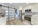 Well-lit kitchen with stainless appliances and decorative barn doors at 515 Leffingwell Ave # 210, Ellenton, FL 34222