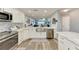 Updated kitchen with stainless steel appliances and view of living space at 515 Leffingwell Ave # 210, Ellenton, FL 34222