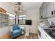 Functional laundry room boasts updated appliances, storage cabinets, and chair at 515 Leffingwell Ave # 210, Ellenton, FL 34222