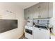 Convenient laundry room features updated appliances and ample storage cabinets at 515 Leffingwell Ave # 210, Ellenton, FL 34222
