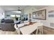 A dining area and living space featuring modern décor and comfortable seating with balcony views at 515 Leffingwell Ave # 210, Ellenton, FL 34222