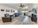 Inviting living room with a ceiling fan, comfortable seating, and a balcony view at 515 Leffingwell Ave # 210, Ellenton, FL 34222