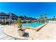 Community pool by boat docks with clear blue water, palm trees, and waterfront condos in the background at 515 Leffingwell Ave # 210, Ellenton, FL 34222